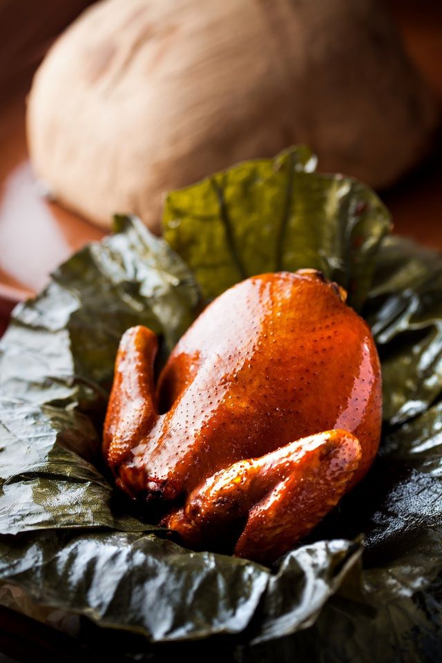 Grilled whole chicken wrapped in lotus leaves