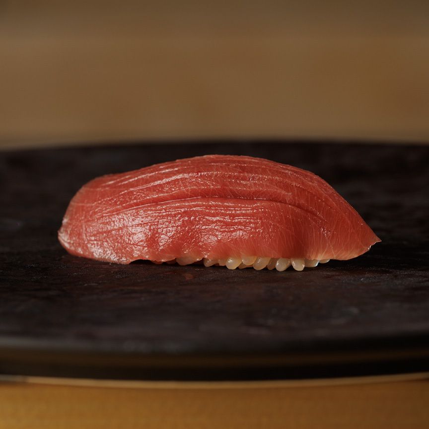 The chef's choice nigiri and appetizer course features 20 dishes of the finest seasonal ingredients, including bluefin tuna, shrimp, and saury.